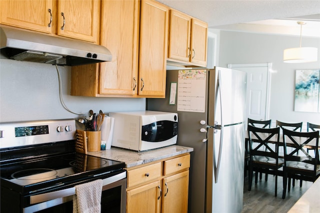 kitchen with white microwave, light brown cabinets, under cabinet range hood, light countertops, and electric stove