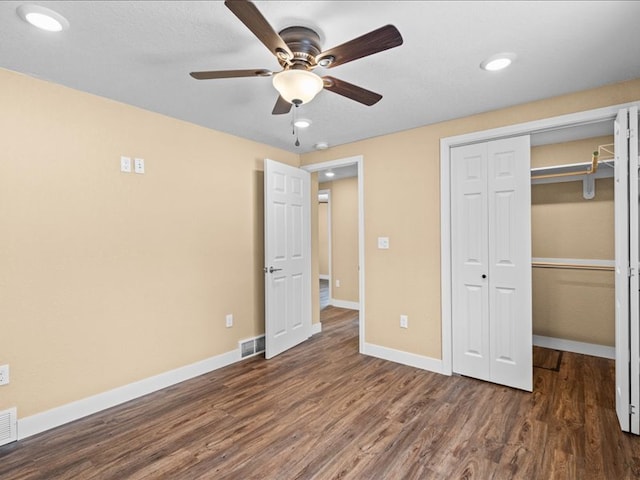 unfurnished bedroom featuring ceiling fan, a closet, and dark hardwood / wood-style floors