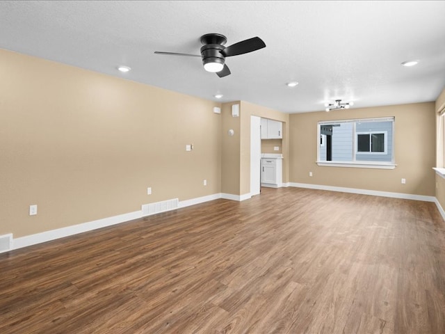 unfurnished living room featuring wood-type flooring and ceiling fan