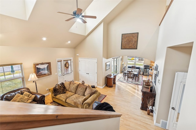 659 Copperwood Ct, Whitefish, MT 59937 - living room featuring plenty of natural light, high vaulted ceiling, light wood-type flooring, ceiling fan, and arched walkways