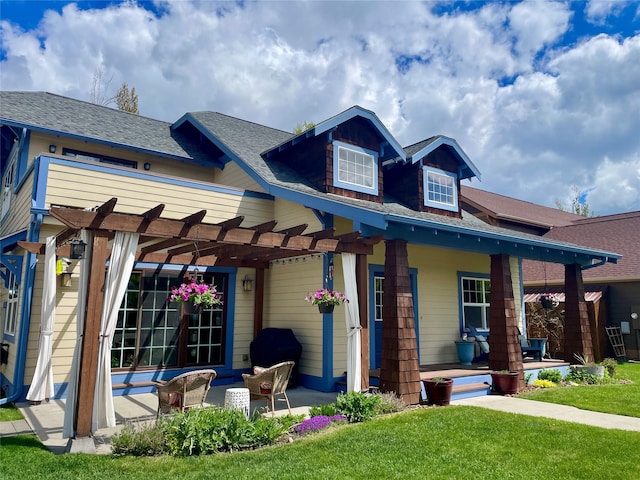 659 Copperwood Ct, Whitefish, MT 59937 - view of front of home featuring a pergola, a porch, a front lawn, and a shingled roof