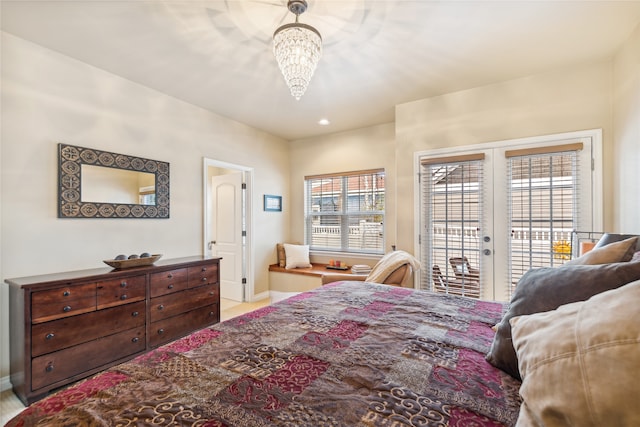 bedroom featuring access to exterior, french doors, a chandelier, and multiple windows