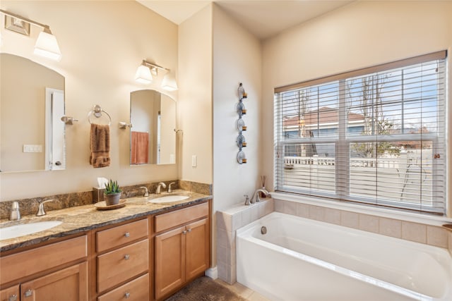 bathroom featuring a tub to relax in and vanity