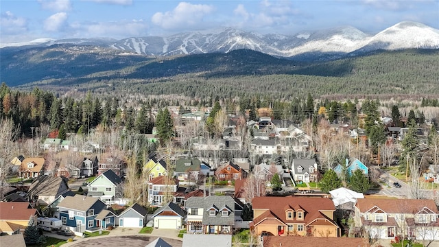 659 Copperwood Ct, Whitefish, MT 59937 - aerial perspective of suburban area featuring a heavily wooded area and a mountainous background