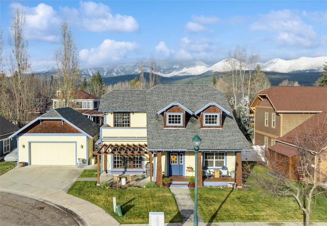 659 Copperwood Ct, Whitefish, MT 59937 - view of front facade with a mountain view, driveway, a front yard, a porch, and roof with shingles