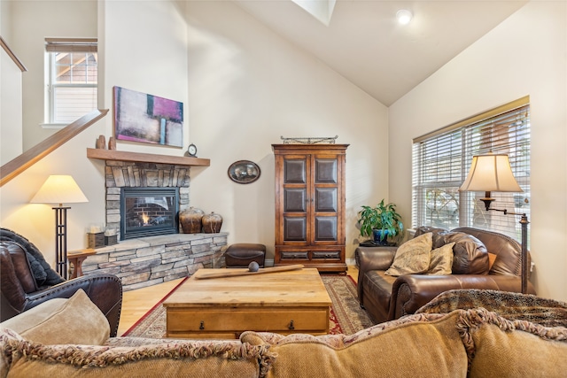 living room with a fireplace, high vaulted ceiling, and wood-type flooring