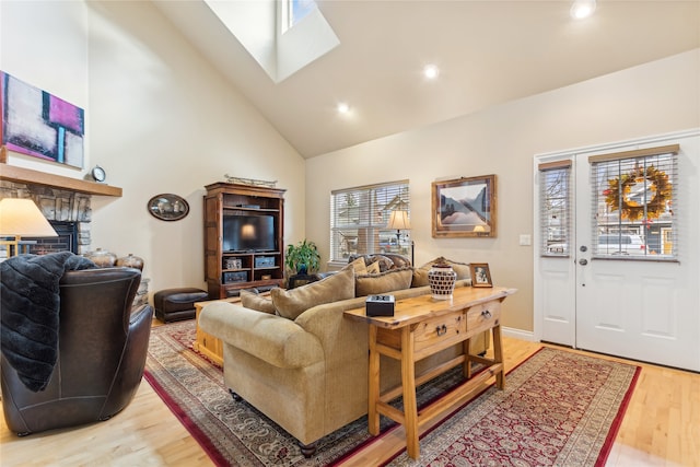 living room with hardwood / wood-style floors and high vaulted ceiling