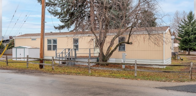 view of front of home featuring a storage unit