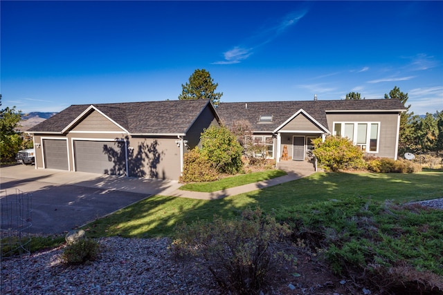 view of front of property featuring a garage and a front lawn