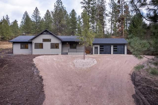 view of front of home featuring a porch and a garage