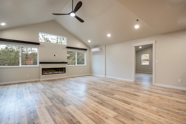 unfurnished living room featuring ceiling fan, light hardwood / wood-style flooring, high vaulted ceiling, and a wall mounted AC