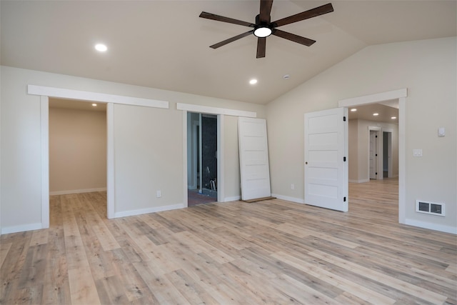 interior space with vaulted ceiling, ceiling fan, and light wood-type flooring