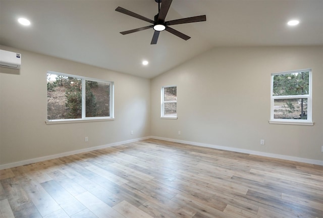 spare room with lofted ceiling, ceiling fan, light hardwood / wood-style floors, and a wall mounted AC