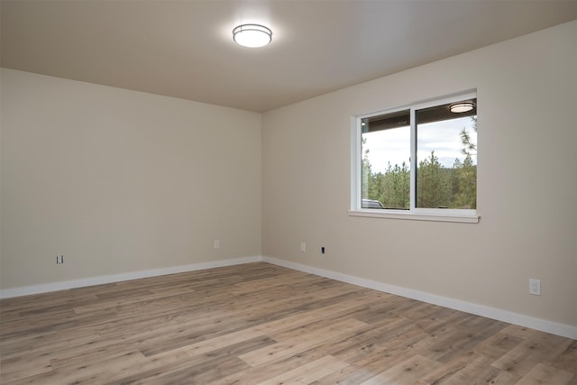 unfurnished room with light wood-type flooring