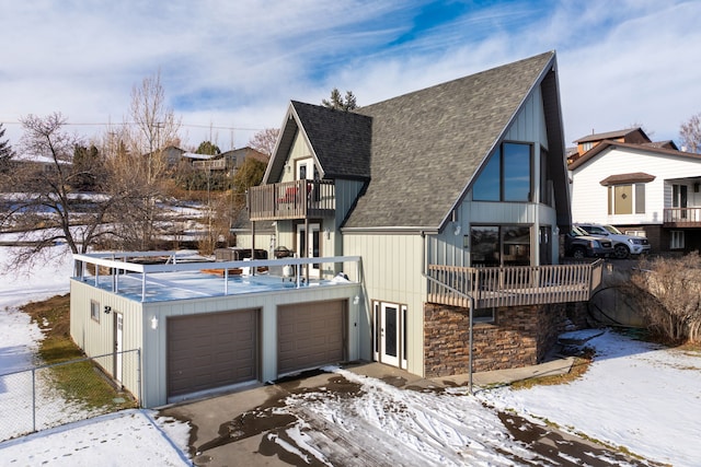 view of front of home featuring a garage and a balcony