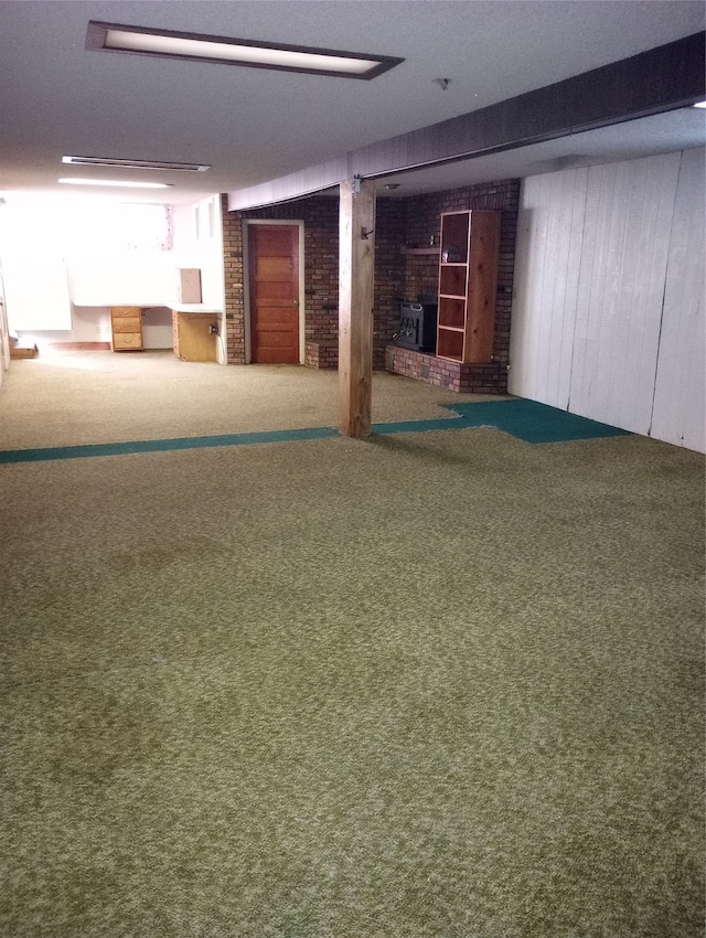 basement with carpet flooring and wooden walls