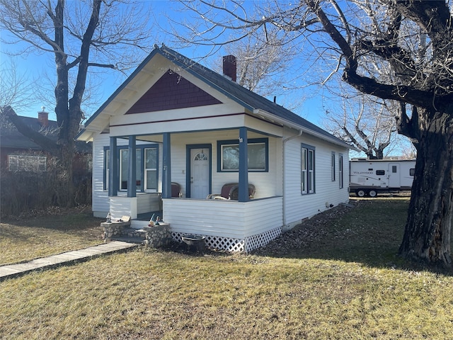 bungalow-style house with a front lawn and covered porch