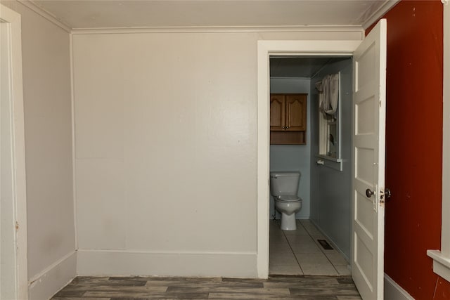 bathroom featuring hardwood / wood-style flooring and toilet