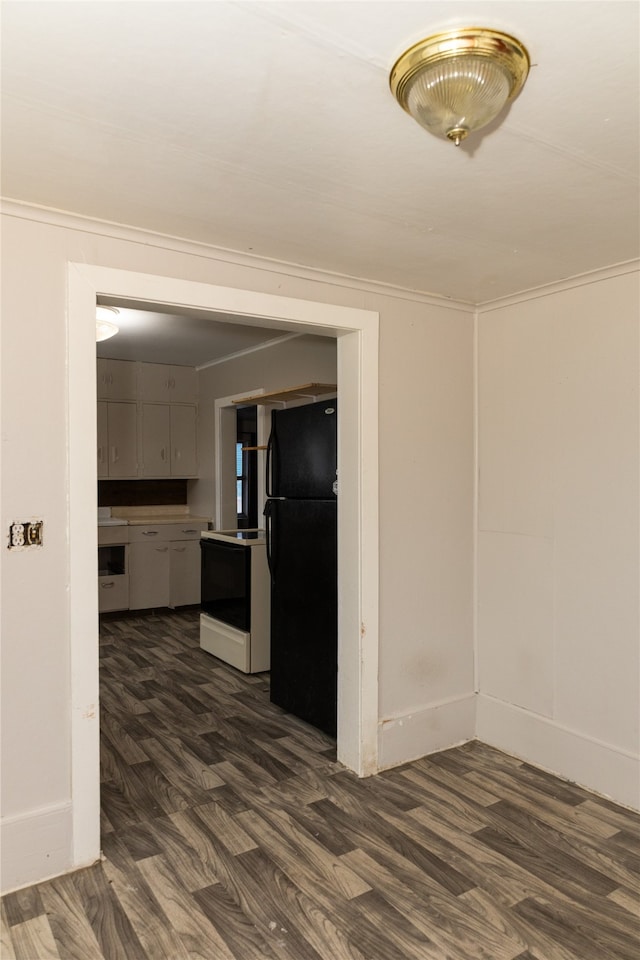 kitchen featuring black refrigerator, white electric range, crown molding, and dark wood-type flooring