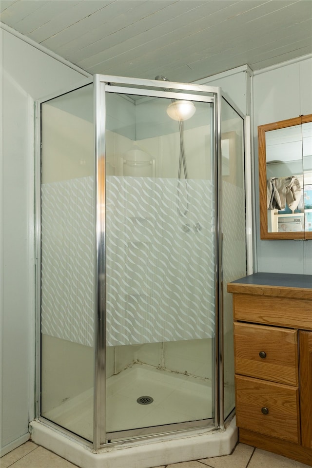 bathroom with tile patterned flooring, vanity, and an enclosed shower