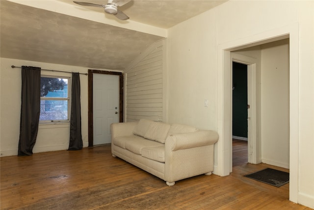 unfurnished living room with wood-type flooring, vaulted ceiling, and ceiling fan