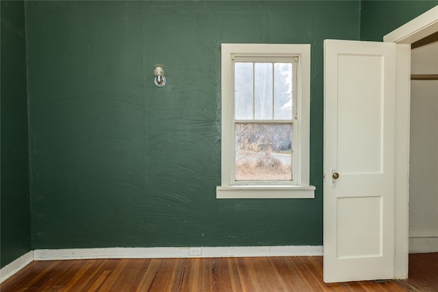 unfurnished room with hardwood / wood-style flooring and a wealth of natural light