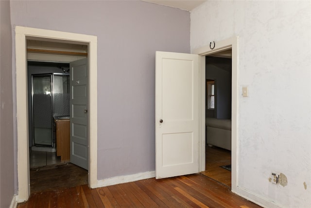 unfurnished bedroom featuring dark hardwood / wood-style floors