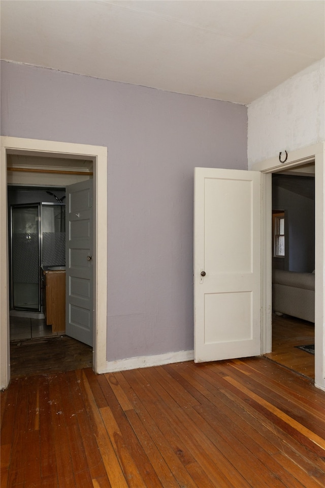 unfurnished room with dark hardwood / wood-style flooring