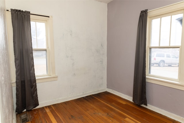 unfurnished room with dark wood-type flooring