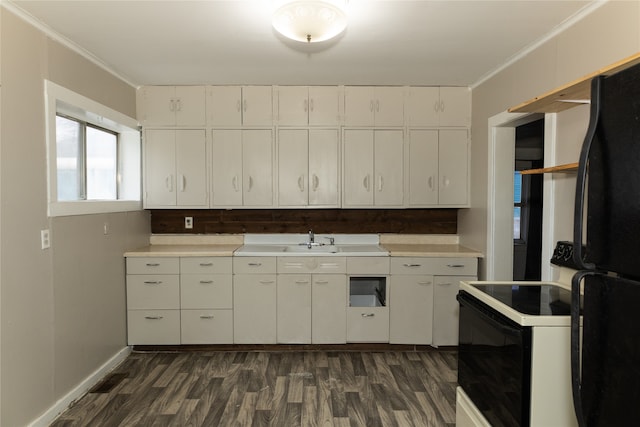 kitchen featuring black refrigerator, dark hardwood / wood-style flooring, ornamental molding, and white cabinetry