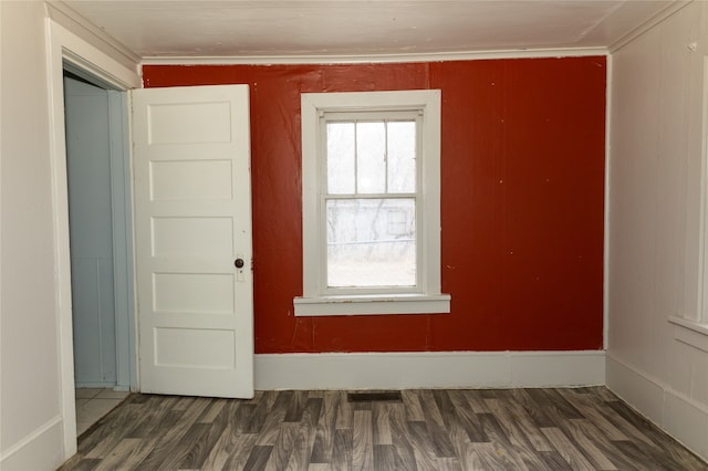 spare room with dark wood-type flooring