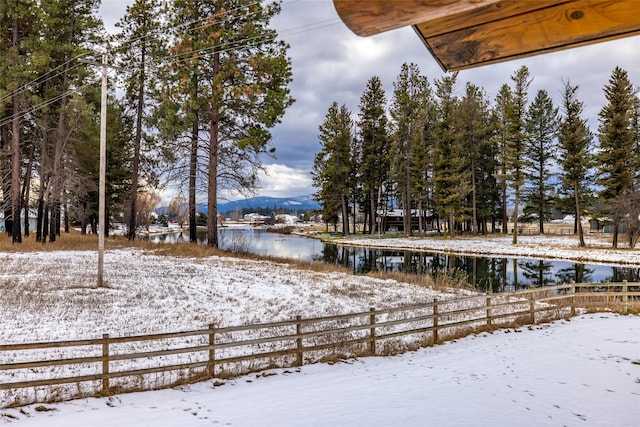 snowy yard with a water view