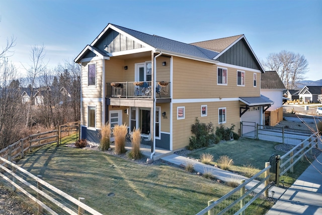 view of front of home featuring a front yard and a balcony