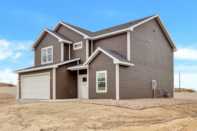 view of front of house with roof with shingles and an attached garage