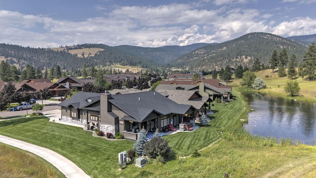 drone / aerial view with a water and mountain view