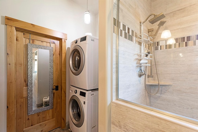 clothes washing area featuring stacked washer / drying machine