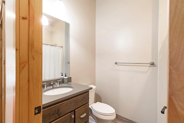 bathroom featuring vanity, a shower with curtain, and toilet