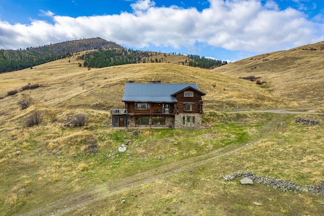 exterior space with a deck with mountain view and a rural view