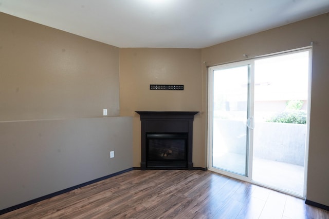 unfurnished living room with hardwood / wood-style flooring