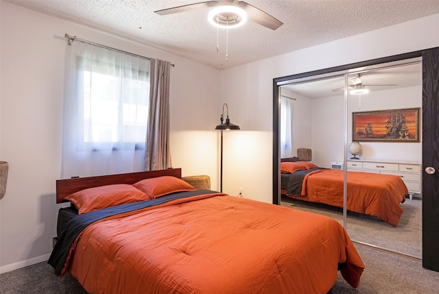 carpeted bedroom with ceiling fan, a textured ceiling, and a closet