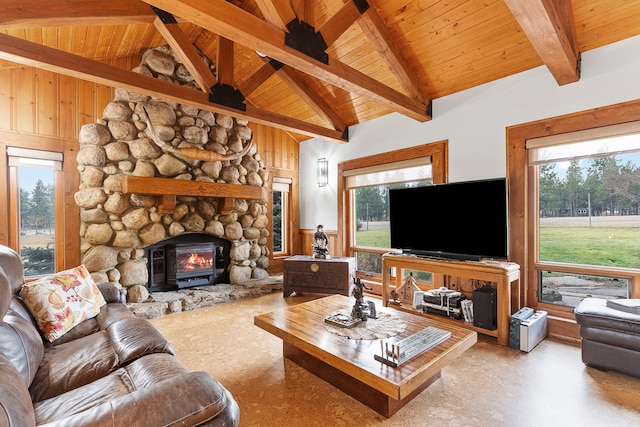 living room with beam ceiling, a wood stove, a wealth of natural light, and high vaulted ceiling