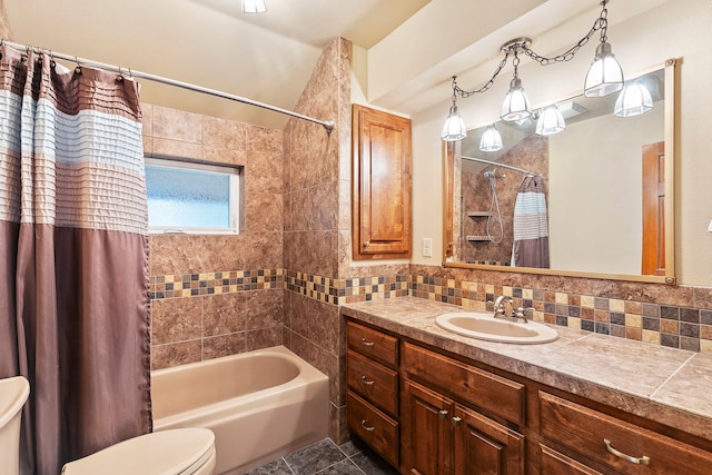 full bathroom with backsplash, vanity, shower / bath combo with shower curtain, tile patterned flooring, and toilet