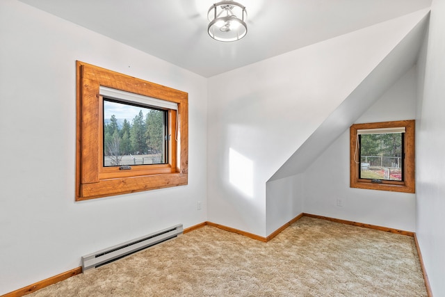 bonus room featuring carpet flooring and a baseboard heating unit