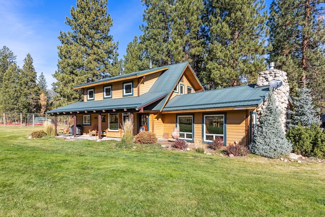 view of front of house with a patio area and a front yard