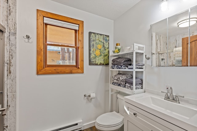 bathroom with a textured ceiling, vanity, toilet, and a baseboard heating unit