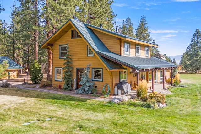 rear view of property with a lawn