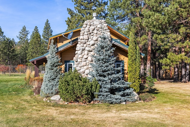 view of home's exterior with a yard