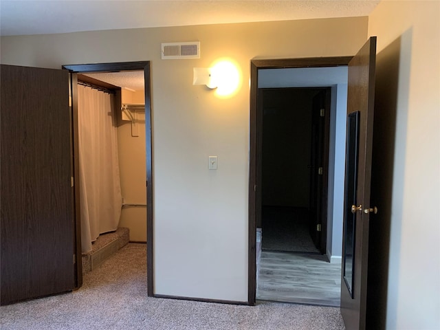 unfurnished bedroom with light hardwood / wood-style floors, a spacious closet, and a closet