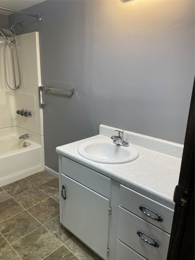 bathroom featuring tile patterned flooring, vanity, and shower / washtub combination