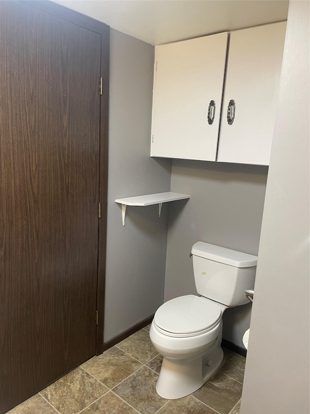 bathroom featuring tile patterned floors and toilet